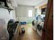 Functional laundry room with modern washer and dryer, utility sink, and exterior access door at 6336 N Carroll Rd, Indianapolis, IN 46235