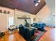 Bright living room featuring a vaulted ceiling, skylights, and hardwood floors at 6336 N Carroll Rd, Indianapolis, IN 46235