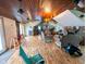 Open living room with a wood-paneled ceiling, a fireplace, and views of an adjoined kitchen and bar at 6336 N Carroll Rd, Indianapolis, IN 46235