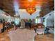 Spacious living room featuring a stone fireplace, wood ceiling, and natural light from many windows at 6336 N Carroll Rd, Indianapolis, IN 46235