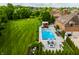 Expansive backyard with a pool, lounge area, and lush green lawn creating a serene outdoor oasis at 6639 E Deerfield Dr, Zionsville, IN 46077