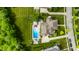 Aerial view showcases a luxury brick house with large backyard and swimming pool in a residential neighborhood at 6639 E Deerfield Dr, Zionsville, IN 46077