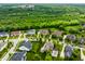 Aerial view showcasing a neighborhood featuring lush green lawns, mature trees and well-maintained homes at 6639 E Deerfield Dr, Zionsville, IN 46077