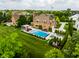 Aerial view showcases the pool and outdoor lounge area in the backyard of a beautiful home surrounded by lush landscaping at 6639 E Deerfield Dr, Zionsville, IN 46077