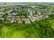 Overhead view of the community and meticulously landscaped yard with a pool and green lawns nestled among mature trees at 6639 E Deerfield Dr, Zionsville, IN 46077