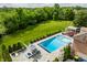 Backyard featuring a pool, a lounge area, beautiful trees, and ample space for outdoor activities and relaxation at 6639 E Deerfield Dr, Zionsville, IN 46077