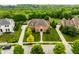 Beautiful aerial view of a two-story brick home with a well-manicured lawn and lush green surroundings at 6639 E Deerfield Dr, Zionsville, IN 46077