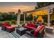 A luxurious backyard lounge area with a covered pergola, outdoor fireplace, and comfortable seating at 6639 E Deerfield Dr, Zionsville, IN 46077
