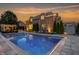 Inviting backyard pool with surrounding patio, lounge chairs, trees, and outdoor seating, perfect for entertaining at 6639 E Deerfield Dr, Zionsville, IN 46077