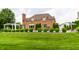 Beautiful brick home featuring a large backyard with a pool and luxurious outdoor entertaining space at 6639 E Deerfield Dr, Zionsville, IN 46077