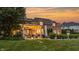 A spacious backyard featuring a large patio with a pergola, an outdoor dining area, and lush greenery at 6639 E Deerfield Dr, Zionsville, IN 46077