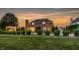 A well-manicured backyard featuring a pool, outdoor lounge area, and mature trees at 6639 E Deerfield Dr, Zionsville, IN 46077