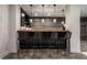 Basement bar featuring pendant lights and four wicker chairs at 6639 E Deerfield Dr, Zionsville, IN 46077