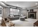 Basement living room featuring a sectional sofa, fireplace, tv, and chairs at 6639 E Deerfield Dr, Zionsville, IN 46077
