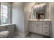 Bathroom featuring vanity, window seat, patterned flooring, and soft natural light at 6639 E Deerfield Dr, Zionsville, IN 46077