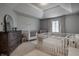 Spacious bedroom with two cribs, a dresser, and soft carpet at 6639 E Deerfield Dr, Zionsville, IN 46077