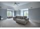 Spacious bonus room with a comfortable sofa, large windows, and neutral decor at 6639 E Deerfield Dr, Zionsville, IN 46077