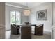 Bright dining area features a round table, stylish chairs, and an elegant chandelier at 6639 E Deerfield Dr, Zionsville, IN 46077