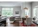 Bright dining area with a wooden table, seating for four, and lots of natural light from large windows at 6639 E Deerfield Dr, Zionsville, IN 46077