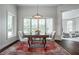 Cozy dining room featuring a square table, seating for four, a large window, and a patterned rug at 6639 E Deerfield Dr, Zionsville, IN 46077