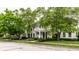 Charming white home with a welcoming porch, set on a beautifully landscaped lot with mature trees at 6639 E Deerfield Dr, Zionsville, IN 46077