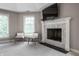 Bedroom sitting area by the fireplace with herringbone tile surround at 6639 E Deerfield Dr, Zionsville, IN 46077