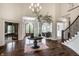 Grand foyer with hardwood floors, high ceilings, elegant chandelier, staircase, and stylish decor at 6639 E Deerfield Dr, Zionsville, IN 46077