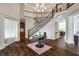 Stunning foyer with hardwood floors, a curved staircase, and elegant decor featuring a stylish entry table at 6639 E Deerfield Dr, Zionsville, IN 46077