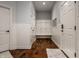Hallway with a mudroom-style bench, white walls, and a hardwood floor at 6639 E Deerfield Dr, Zionsville, IN 46077