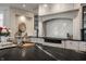 Close-up of the kitchen island featuring a black countertop, brass faucet, and gray and white cabinets at 6639 E Deerfield Dr, Zionsville, IN 46077