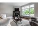 Cozy living room with a fireplace, large window, comfortable seating, and stylish furnishings at 6639 E Deerfield Dr, Zionsville, IN 46077