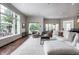 Open-concept living room with a fireplace, a large window, and cozy seating leading to the outdoor living spaces at 6639 E Deerfield Dr, Zionsville, IN 46077