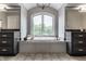 Main bathroom with soaking tub and dual vanities under a large window at 6639 E Deerfield Dr, Zionsville, IN 46077