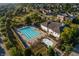 Aerial view of a community pool area with a large pool, kiddie pool, lounge chairs, and verdant landscaping at 6639 E Deerfield Dr, Zionsville, IN 46077