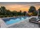 A stunning swimming pool with an expansive patio, lounge chairs, and lush landscaping at 6639 E Deerfield Dr, Zionsville, IN 46077