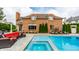 An inviting backyard featuring a pool, spa, outdoor lounge area, and lush landscaping at 6639 E Deerfield Dr, Zionsville, IN 46077