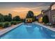A beautiful swimming pool with an outdoor lounge area and a view of the expansive backyard at 6639 E Deerfield Dr, Zionsville, IN 46077