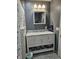 Well-lit bathroom with a marble countertop vanity and cabinets below for ample storage at , Lebanon, IN 46052