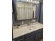 Bathroom with blue cabinets and white countertops and double-door mirror at , Lebanon, IN 46052