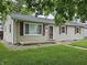Charming single-story home with gray siding, red shutters, and a green lawn at , Lebanon, IN 46052