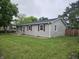 Well-maintained single-story home with gray siding, red shutters, and a spacious front lawn at , Lebanon, IN 46052