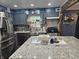 Modern kitchen with gray cabinets, granite countertops, stainless steel appliances, and an island at , Lebanon, IN 46052