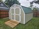 Backyard shed with wood ramp and a white door at , Lebanon, IN 46052