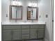 Bathroom featuring dual sinks with modern fixtures and stylish vanity at 7823 Ashtree Dr, Indianapolis, IN 46259