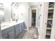 Stylish bathroom with a double sink vanity and an open closet space at 7823 Ashtree Dr, Indianapolis, IN 46259