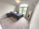 Well-lit bedroom with neutral walls, large window and decorative mirror at 7823 Ashtree Dr, Indianapolis, IN 46259