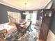 Elegant dining room with stylish rug, wooden table, chandelier, and decor at 7823 Ashtree Dr, Indianapolis, IN 46259
