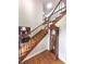 Bright entryway features hardwood floors, oak staircase with decorative iron railing, and a grandfather clock at 7823 Ashtree Dr, Indianapolis, IN 46259