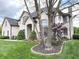 Elegant white brick home with manicured landscaping, mature trees, and a well-maintained lawn at 7823 Ashtree Dr, Indianapolis, IN 46259