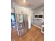 Kitchen featuring stainless steel refrigerator, white cabinets, and a view into the dining room at 7823 Ashtree Dr, Indianapolis, IN 46259
